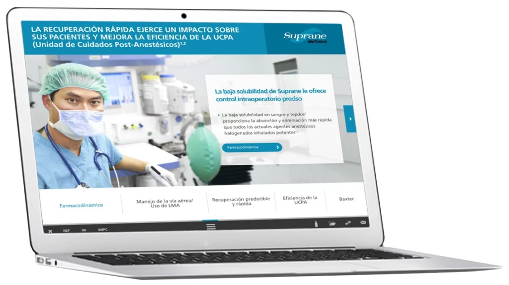Ordenador portátil que muestra una página web médica con un cirujano con equipo de protección en un quirófano y un texto sobre el impacto de Suprane en la eficacia de los cuidados postanestésicos.
